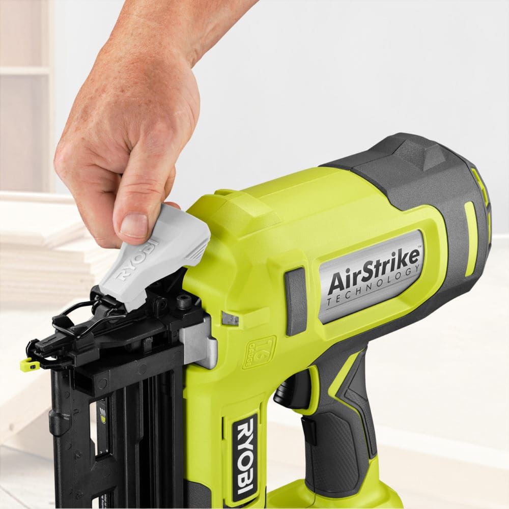 A photo of a man's hand adjusting the air nailer head mechanism, as an example of rich content for Home Depot's website